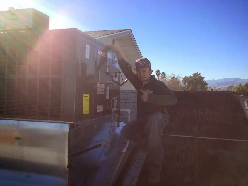 HVAC technician performing Boiler Repair on a rooftop unit in Chester